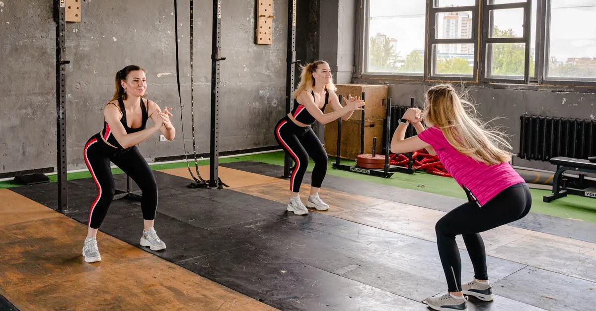 Women doing squats together in a bootcamp workout